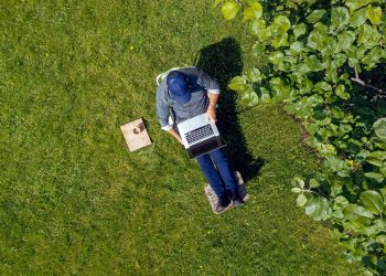 Man using laptop in garden